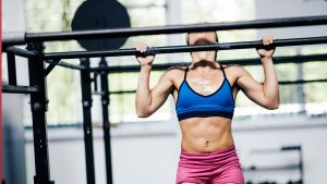 Determined girl doing pull-ups