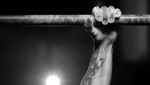 Male hand holding pull ups bar